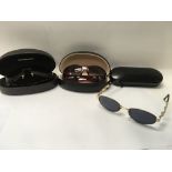 Three pairs of cased designer sunglasses, includin