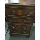 A small reproduction chest of drawers fitted with