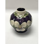 A small moorcroft vase decorated in the Violet win