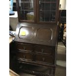 An oak bureau bookcase with lead light glazed door