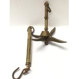 A small brass collapsible anchor and vintage brass