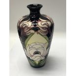 A moorcroft vase decorated in the English miss pat