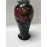 A early moorcroft pomegranate pattern vase on a bl