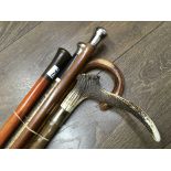 Five walking canes including silver top and horn