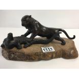 A Japanese bronze figure group depicting a Lion at