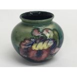 A small Moorcroft vase decorated with flowers and