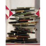 A collection of vintage fountain pens and pencils