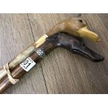 Two novelty carved walking sticks, the handles in the form of dog and duck