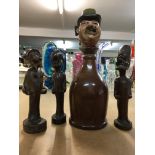 Three carved novelty pipes and a novelty bottle an