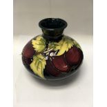 A Moorcroft vase decorated with fruit and foliage