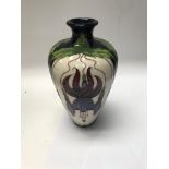 A moorcroft vase decorated in the fuchsia pattern
