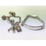 A silver charm bracelet and a silver ID bracelet.