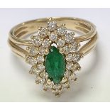 A 14ct gold ring set with a central emerald and fl