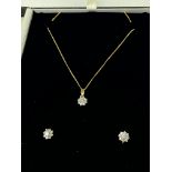 An 18ct gold and diamind set pendant and matching