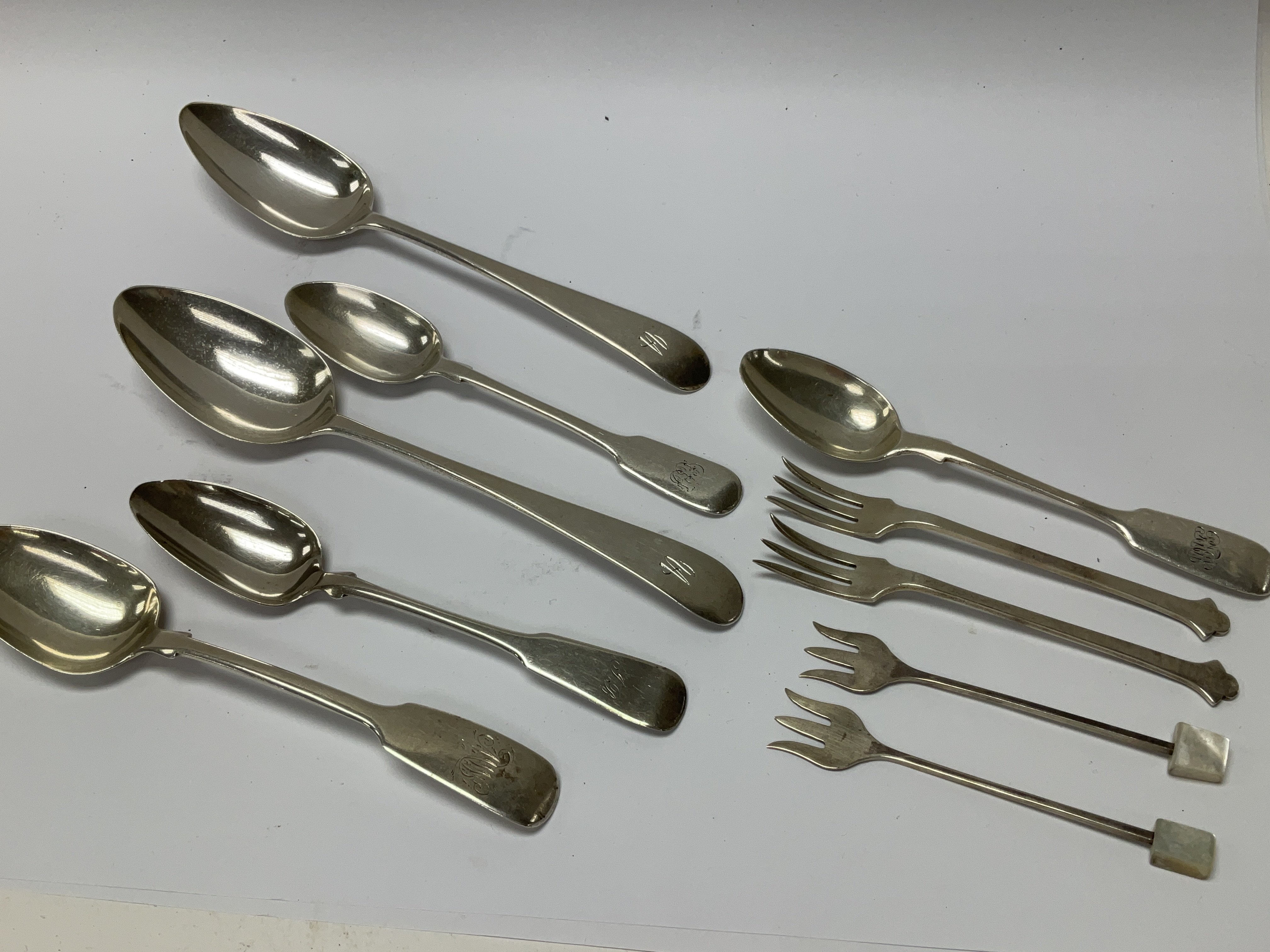 A collection of silver spoons and small forks incl