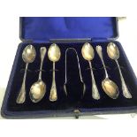 A cased set of silver spoons with tongs together w
