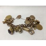 A 9 ct gold charm bracelet total weight 97 grams .