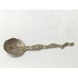 A Chinese silver spoon with a dragon running along