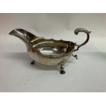 A silver cream jug with c scroll handle on shaped