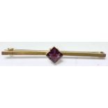 A 9ct gold brooch set with a singular amethyst.