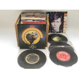 A box of 7inch singles by various artists including The Beatles, David Bowie and others. NO