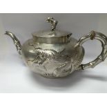 A Chinese silver three piece tea set decorated wit