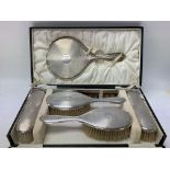 A silver dressing table set, cased.