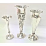 Three fluted Hallmarked silver candlesticks weighi