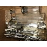 A box of silver items including cutlery and bottle