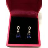 A pair of 9ct white gold drop earrings set with di