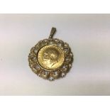 A 1917 gold sovereign fitted in a 9 ct gold pendan