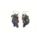 A pair of silver and enamel earrings in the form o