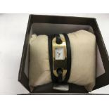 A boxed Gucci ladies wrap around watch.