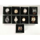 A collection of nine watches, seen working.