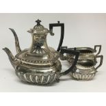 A four piece silver tea set with half fluted sides