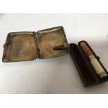 A silver cigarette case and an amber silver mounte