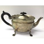 A silver teapot with faded hallmarks weighing in t