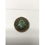 A 15ct gold brooch set with turquoise.