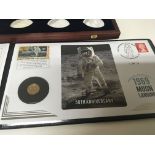 A gold Moon Landing Commemorative coin cover and a