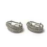 A pair of 18ct white gold and pave diamond set ear