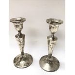 A pair of sterling silver candlesticks, weighing i