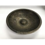 An Islamic bronze bowl with engraved decoration, a