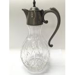 A cut glass claret jug measuring approximately in