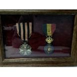 Two framed Dutch medals.