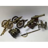 A collection of six brass cannons and a miniature