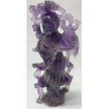 A carved purple rock crystal figure.