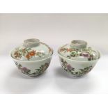 A pair of Oriental tea bowls with covers and decor