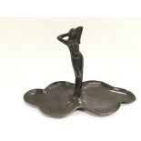 A bronze Art Nouveau figure of a maiden standing o