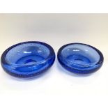 Two graduated blue glass bowls, largest diameter a