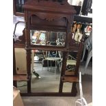 An Edwardian walnut overmantel m fitted with bevel